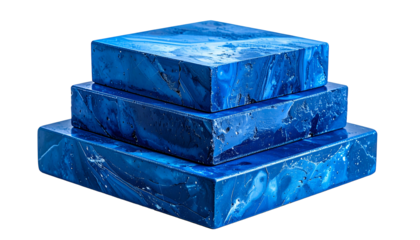 Three layered, geometric blocks of vibrant blue stone appear stacked, resembling a tiered cake