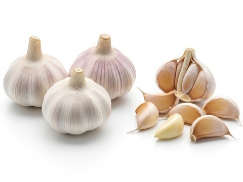 Fresh garlic bulbs and cloves with natural texture, isolated on white background.