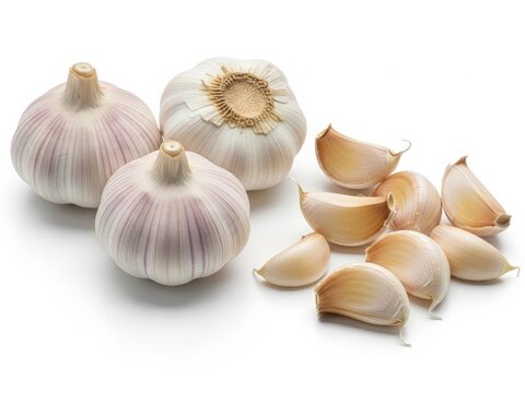 Fresh garlic bulbs and cloves with natural texture, isolated on white background.