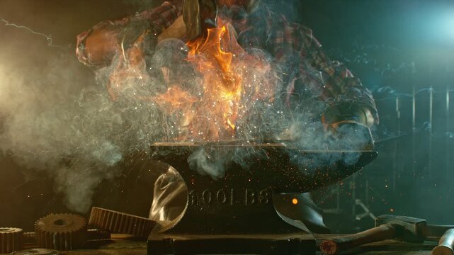 Cinematic close-up of blacksmith forging glowing hot iron on anvil with sparks flying. Shot in dramatic lighting on dark background with high-speed camera at 1000fps. Camera in motion. Speed Ramp.