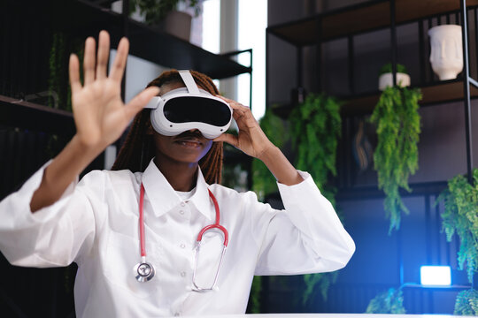 Portrait African female doctor using vr headset for medical simulation and gesture control. Futuristic interactive med technology AI assistant for data analysis concept. - Powered by Adobe
