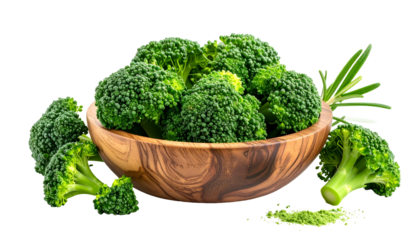 A wooden bowl overflowing with fresh broccoli florets and a sprig, isolated on black