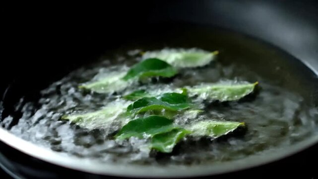 Curry Leaves Added to Hot Oil in a Pan for Tempering Indian Cuisine