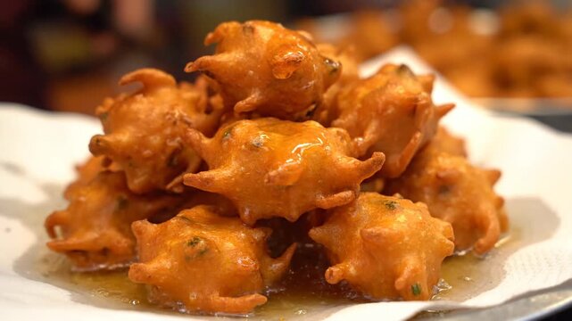 Crispy hot Indian Pakora fritters served on a plate street food snack