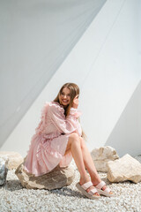 Sunlit Model In Summer Attire, Model Enjoying Sunny Weather In Fashionable Vacation Wear On Stones