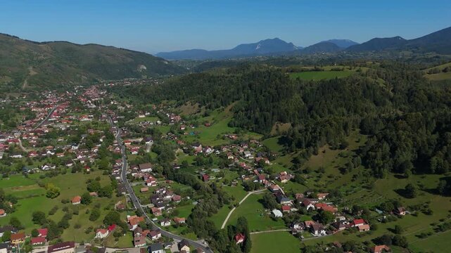 Wide Aerial Reveal of Moieciu de Jos Tourism Resort and Bran Village in a clear blue sky day