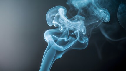 Fototapeta premium A close up photograph of swirling blue smoke on a dark background with a gradient of light to dark with swirling smoke and smoke pattern