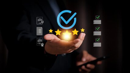 Businessman hand showing virtual five star rating, quality assurance checkmark and standard...
