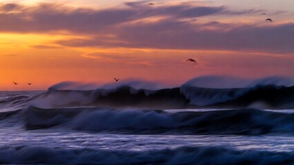 Dramatic ocean waves crashing under a vibrant twilight sky with silhouettes of birds in graceful