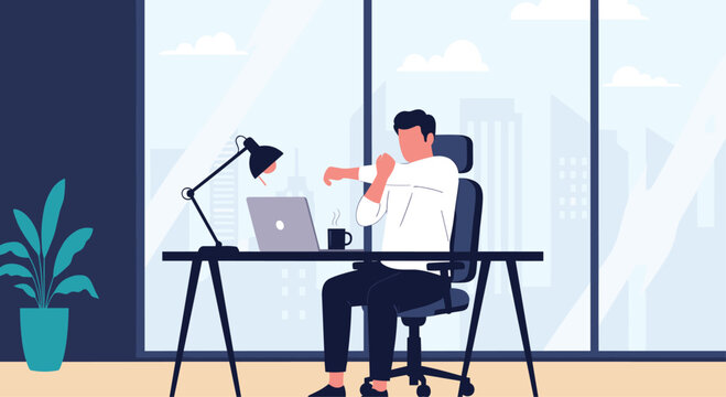 Male office worker taking a short break to stretch his arms and back while sitting at his desk in a modern office.