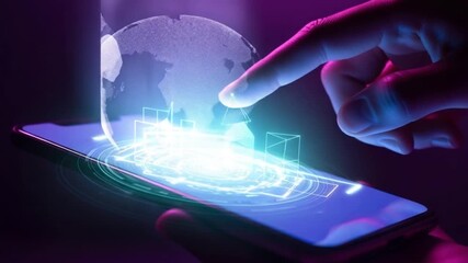 A hand interacting with a smartphone displaying a futuristic interface with a glowing globe and geometric shapes on the screen - Powered by Adobe