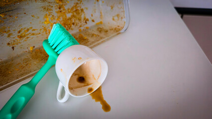 Dirty kitchen dishes with sponge and brush