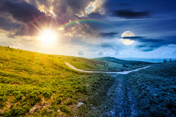 country dirt road through mountains. day and night time change concept. scenic view of green rolling hills under sky with clouds with sun and moon at twilight. duality and transition template