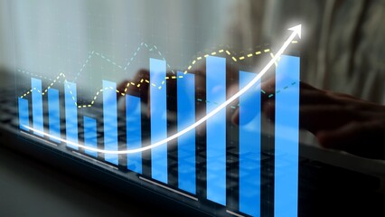 A close-up image demonstrating business growth through digital graphs and charts over a keyboard, symbolizing data analysis and financial success in modern technology. Copula