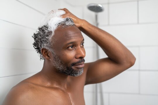 Mature african male showering: self-care routine with shampoo and relaxation - Powered by Adobe