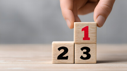 Hand placing number one on achievement ranking blocks