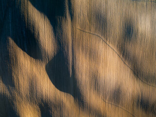 An abstract aerial view of the rolling agricultural fields in Tuscany near Buonconvento, showcasing...