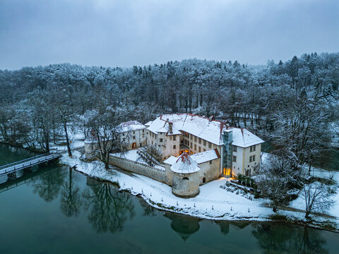 The medieval Otočec Castle, Slovenia's only water castle, situated on a small island in the Krka River, showcasing its Gothic and Renaissance architecture