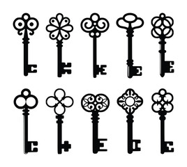 Collection of ornate black antique skeleton keys with decorative bow