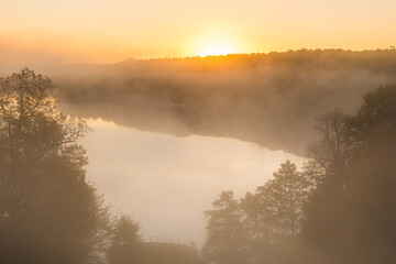 Sunrise at misty lake in Aspen near Gothenburg in Sweden creates a peaceful morning scene
