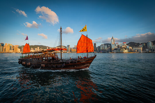 Awesome view of a tourist junk boat in Victoria Harbour in front of Hong Kong's fantastic skyline and impressive skyscrapers
