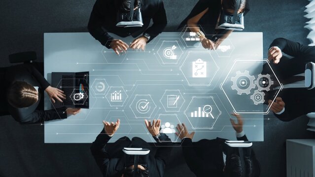 A modern business team collaborates using virtual reality technology for data analysis, enhancing strategy development and communication in a contemporary workspace. Raster - Powered by Adobe