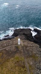 Lighthouse on the rugged coast line of Iceland