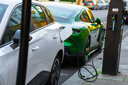 Porsche Taycan EV, Electric Vehicle Supply Equipment (EVSE), Morris Garages MG MG4 Car Public Kerbside Charging Station, Notting Hill, London, England, UK, Britain