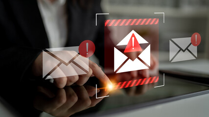 A professional person interacts with a tablet, receiving crucial email alerts about potential threats and security issues, emphasizing the importance of digital safety. Gantry