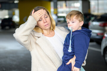 Stressed Mother Holding Tired Toddler