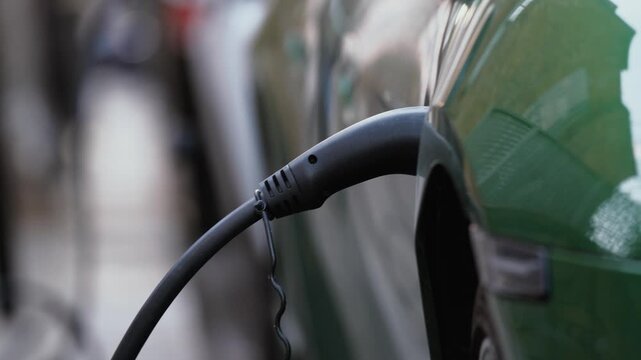 EV Charger, Charge Point, Electric Vehicle Supply Equipment (EVSE) Plugged Into Car Public Charging Station, London, England, UK, Britain