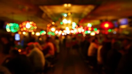 Blurry view of a lively bar filled with colorful lights and patrons enjoying their time. A vibrant nightlife atmosphere perfect for social gatherings and celebrations