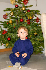 Toddler Sitting Before Christmas Tree