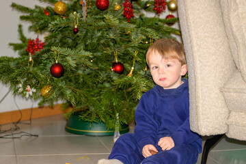 Toddler Sitting Beside Christmas Tree