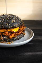 Vegan pulled mushroom burger on dark background