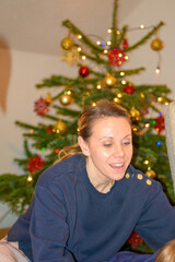 Woman Leaning Near Christmas Tree
