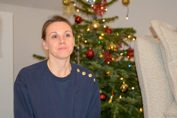 Woman Sitting Beside Christmas Tree