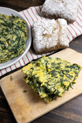 Spinach farinata with bread and kitchen towels
