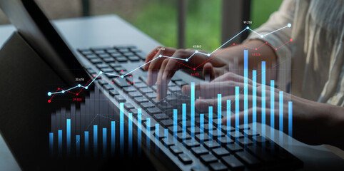 A close-up view of hands typing on a keyboard with a digital graph overlay, illustrating data analytics in a modern office. Perfect for themes of technology and business progress. Scalp