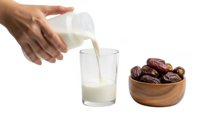 Pouring milk into glass near bowl of dates