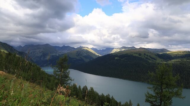 Landscape with mountains, clouds, and Lake Taimen. Altai, Russia. Timelapse
