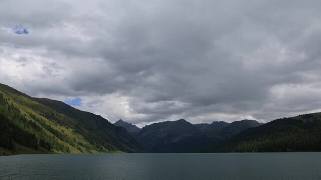 Landscape with mountains, clouds, and Lake Taimen. Altai, Russia. Timelapse