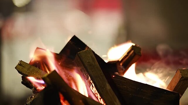Burning firewood in metal brazier on snowy winter evening