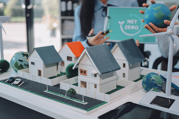 Hands of adult Asian business professionals analyzing ESG financial data and renewable energy project plans