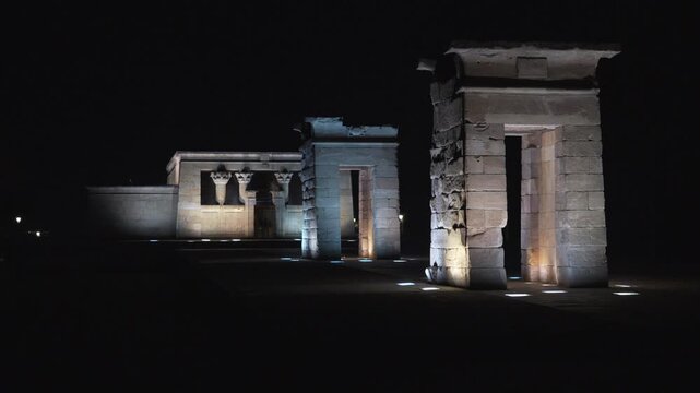Madrid, Spain - December 30, 2025:  Templo de Debod. A group of three stone buildings lit up at night. The buildings are arranged in a row, with the middle one being the tallest.