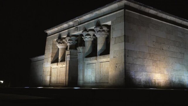 Madrid, Spain - December 30, 2025: Templo de Debod. A building with a lot of pillars and a large entrance. The building is lit up at night.