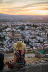 Fototapeta premium Tourists and locals watching the sunset over the Alhambra and Albaicin from San Miguel Alto