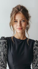 A woman wearing a black dress with silver embroidery on it
