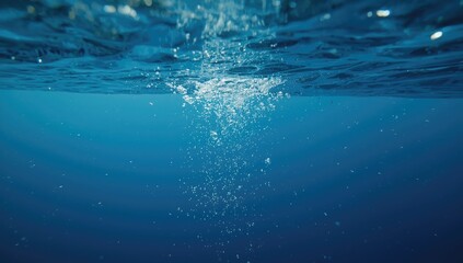 Blue sea with ascending bubbles, illustrating underwater movement and water dynamics