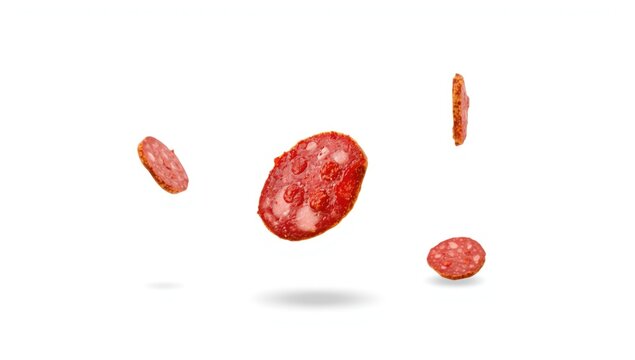 Sausage slices suspended against a plain backdrop, highlighting food preparation techniques